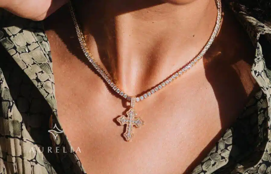 moissanite cross pendant on. MODEL'S NECK