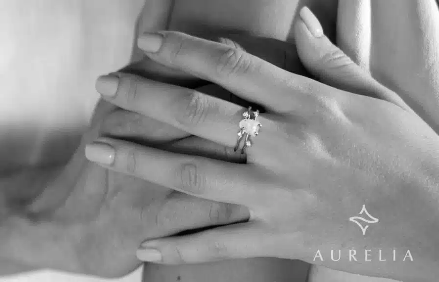 moonstone engagement ring on a couples hand