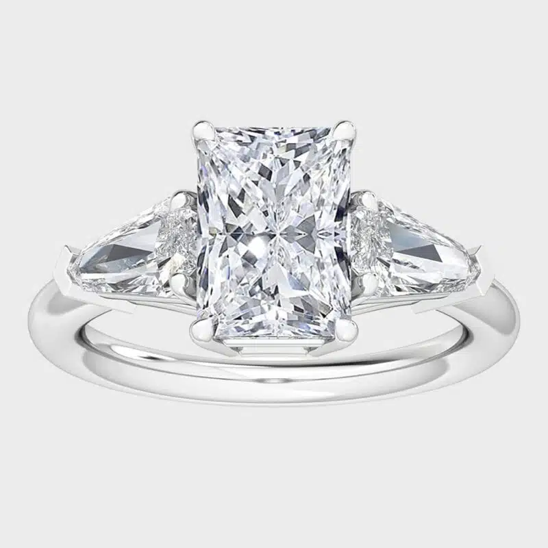 Shop 1 carat lab-grown radiant shield-cut three-stone engagement rings below $1000. D-E color, VS1-VS2 clarity, crafted in 14k white gold.