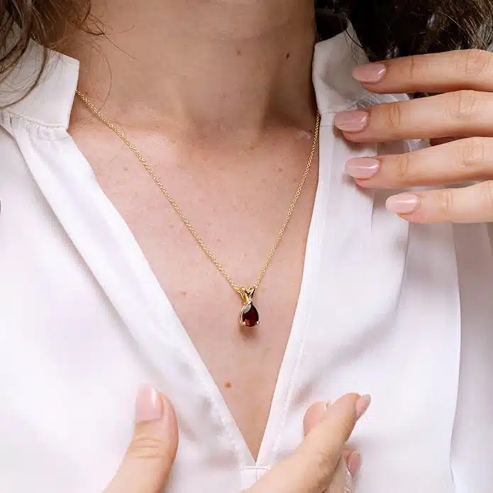 Elegant pear-shaped garnet solitaire pendant in silver, gold, or platinum. Perfect January birthstone gift for birthdays, anniversaries, or weddings.