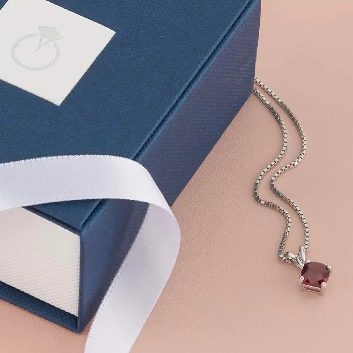 Discover the luxurious Peora Garnet Gold Pendant for women, featuring a deep plum-red gemstone in 14K white gold. Perfect January birthstone gift.