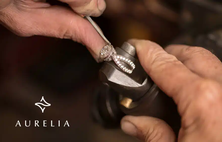 A Jeweler resizing a white gold diamond ring at his workbench