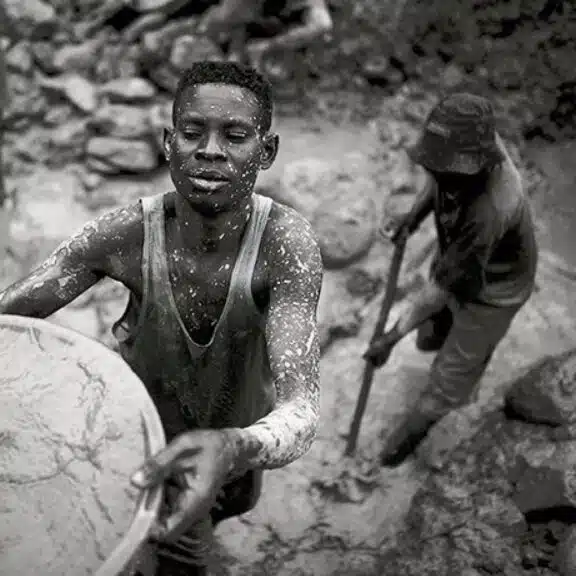 A worker mining diamonds in harsh conditions, highlighting why some diamonds are referred to as conflict materials.