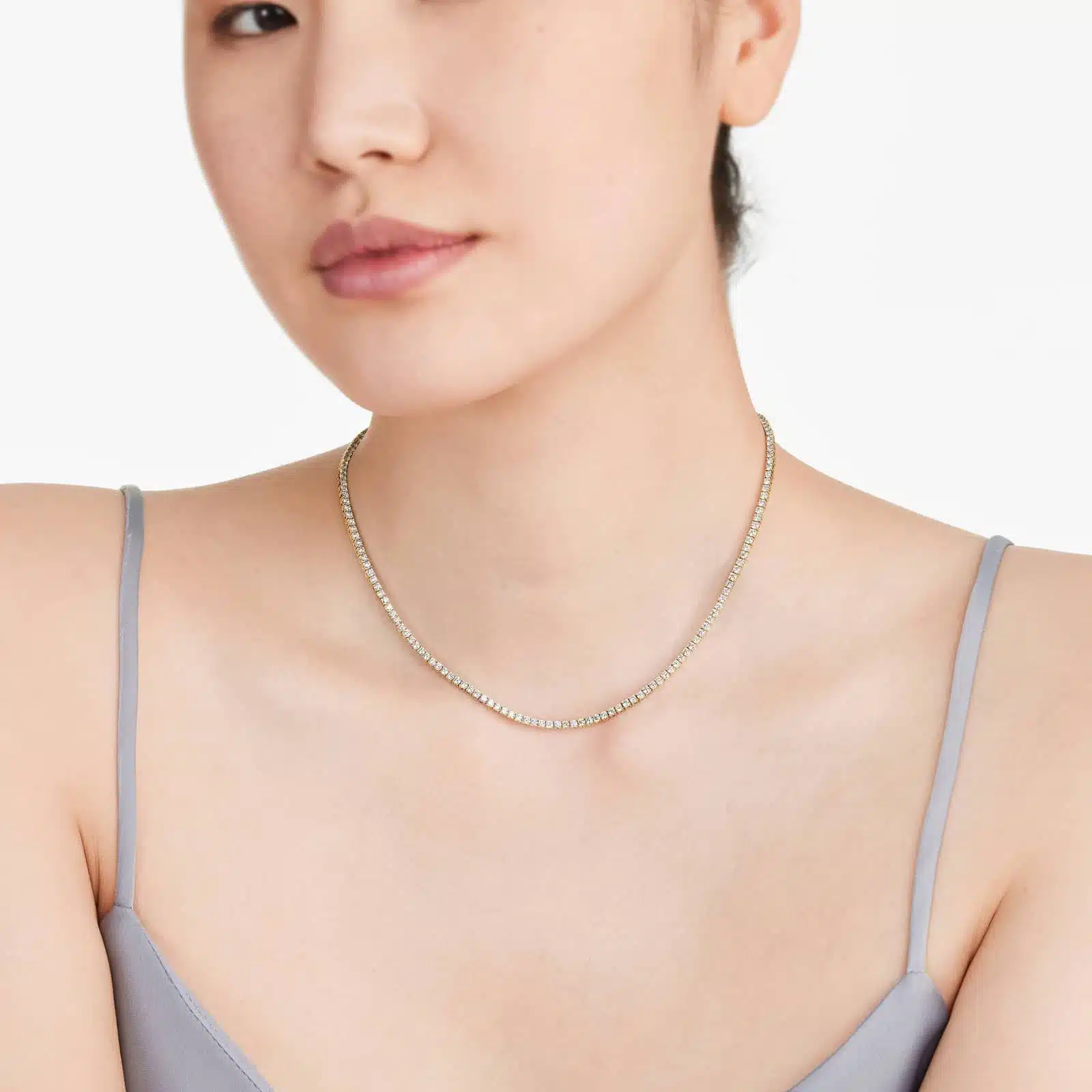 Woman wearing a floating diamond tennis necklace, showcasing 5.00 CTW lab-grown stones in 14K yellow gold for daily elegance