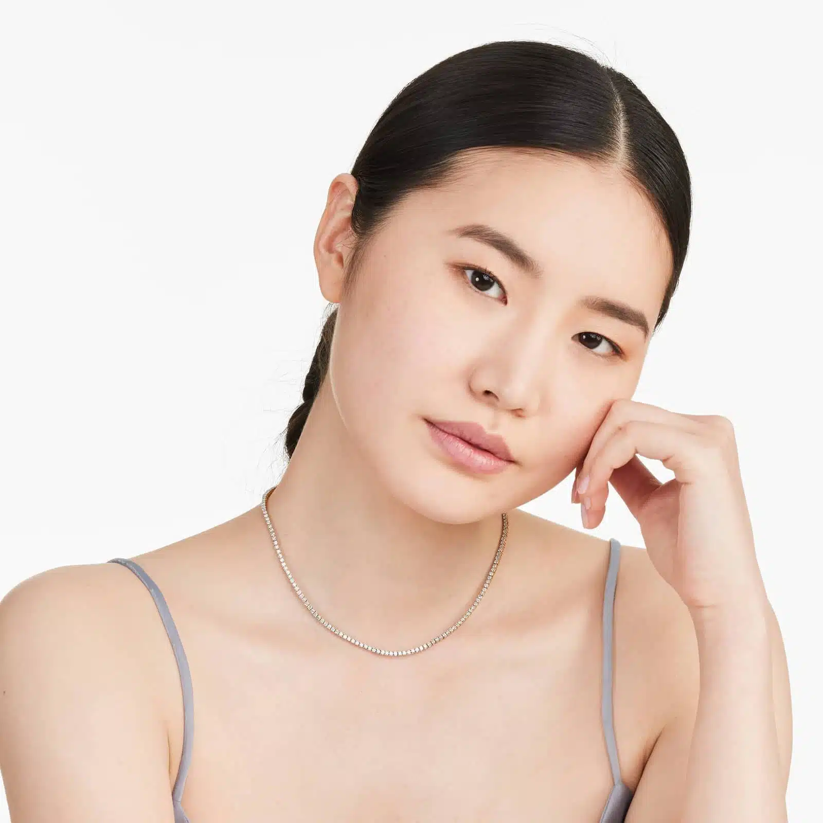 Woman wearing a floating diamond tennis necklace, showcasing 5.00 CTW lab-grown stones in 14K yellow gold for daily elegance