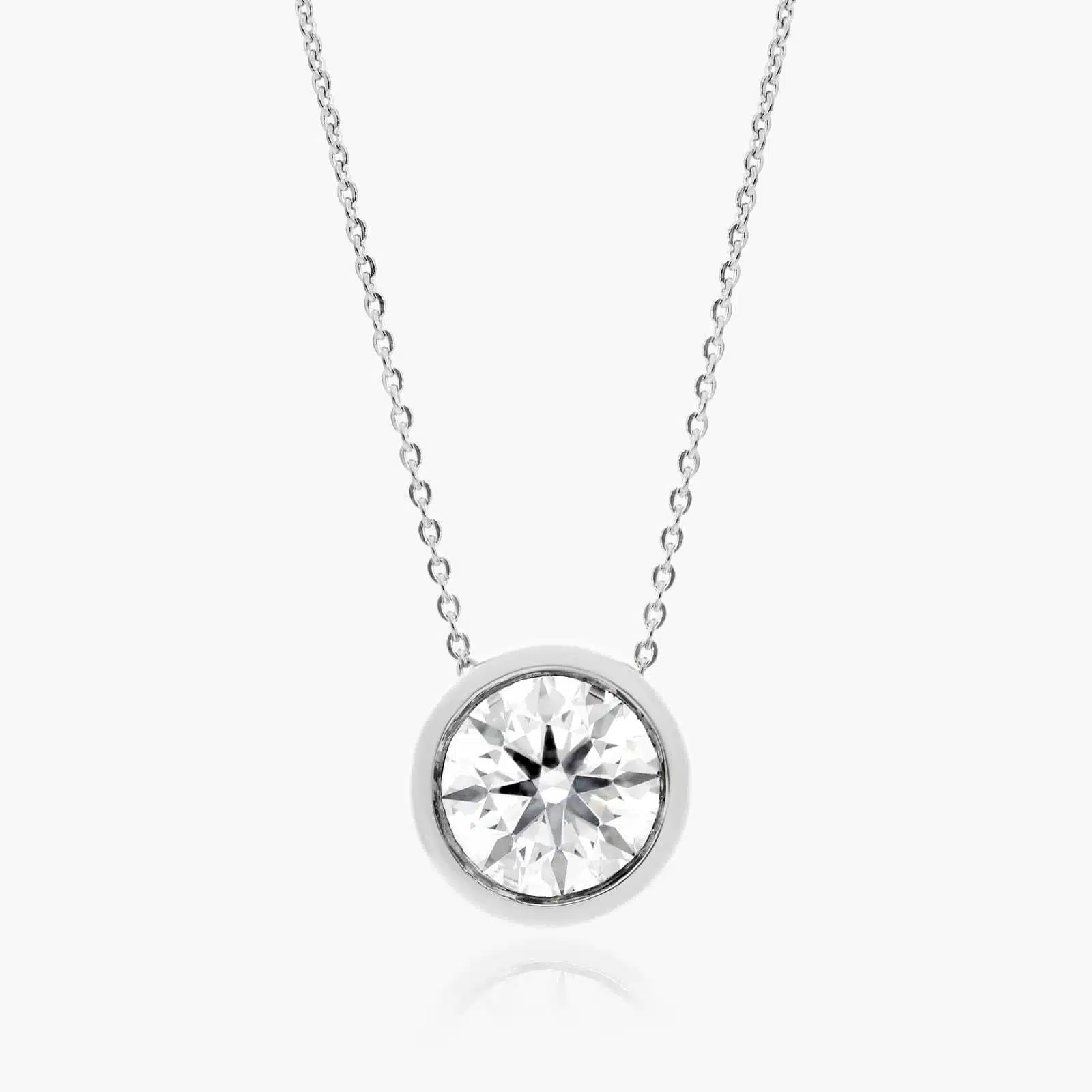 A 0.50 CTW diamond appears to float in a secure 14K white gold bezel setting. Adjustable 16-18" chain.