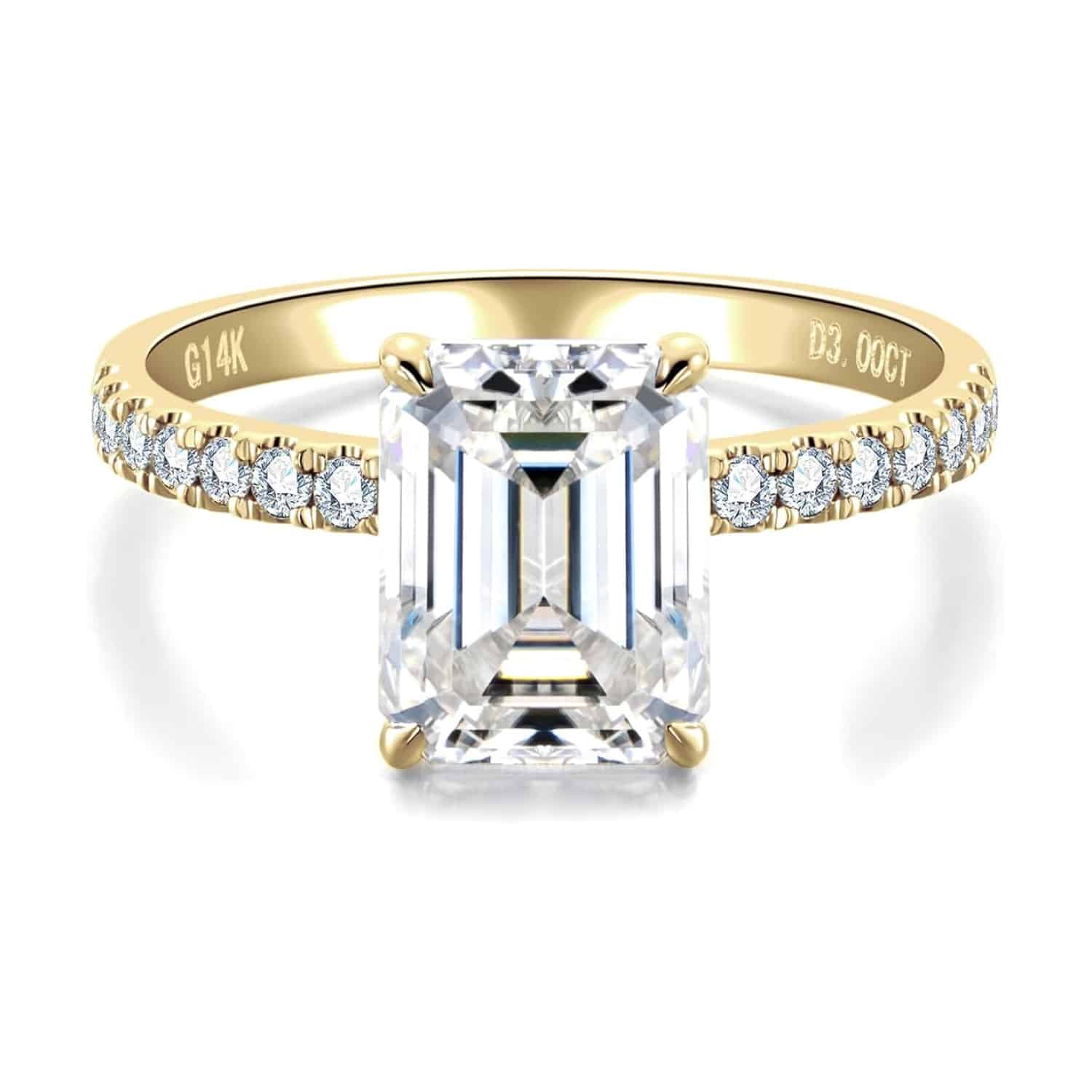 Elegant 3 carat emerald cut moissanite ring with side stones in 14K solid gold from CADYNO. Perfect for weddings & anniversaries.