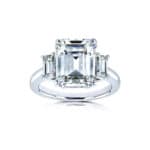 Kobelli 5.5 carat TGW emerald cut moissanite three-stone statement ring in 14k white gold. Shop this luxury engagement ring!