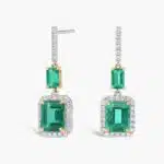 A stunning cascade of vibrant green emeralds and brilliant diamonds, expertly set in luxurious 18k yellow and white gold.