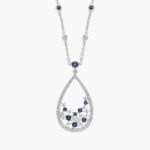 An intricate floral teardrop pendant crafted with deep blue sapphires and brilliant diamonds, hanging from a delicate 18k white gold cable chain.
