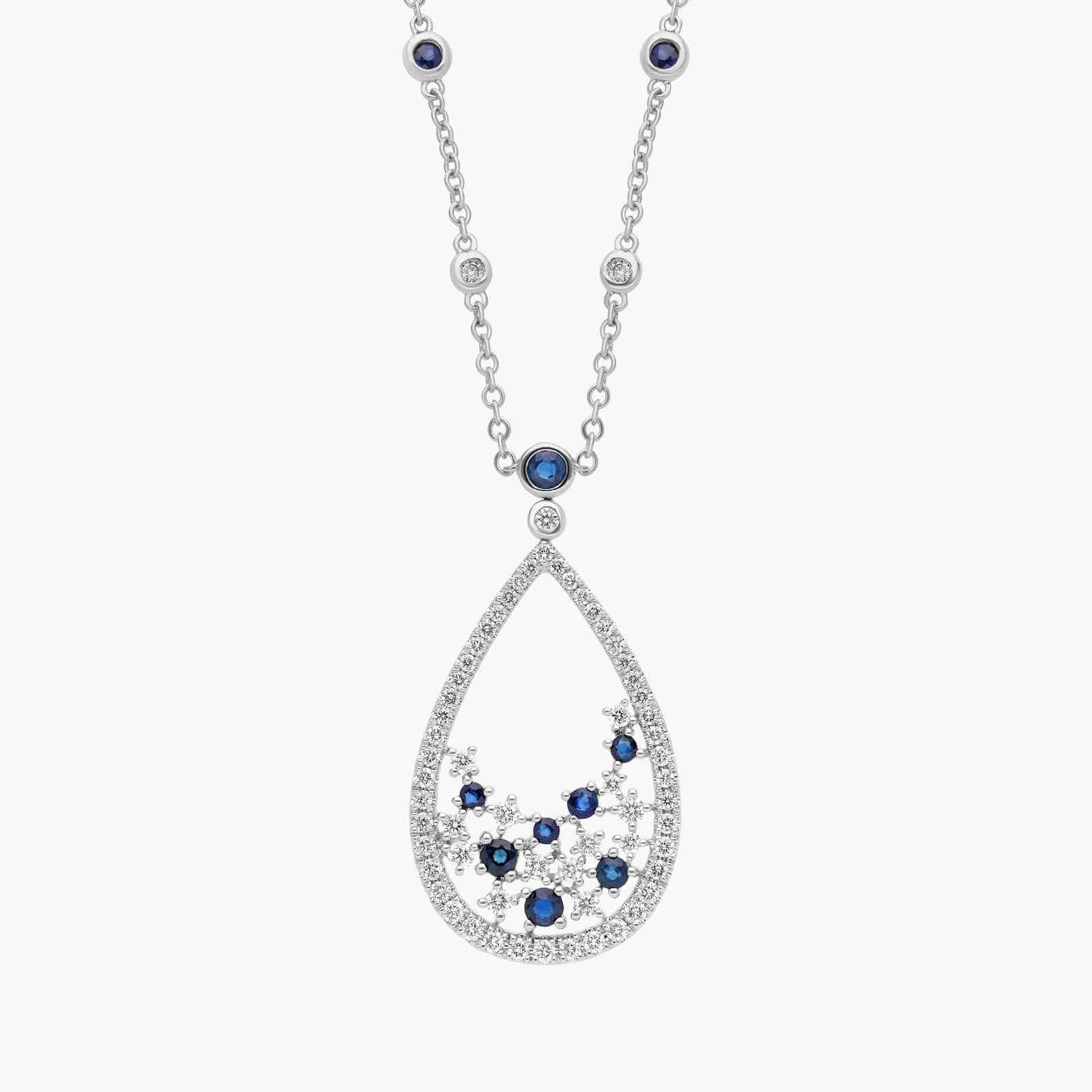 An intricate floral teardrop pendant crafted with deep blue sapphires and brilliant diamonds, hanging from a delicate 18k white gold cable chain.