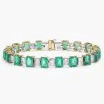 A breathtaking masterpiece featuring 19 vibrant green emeralds and over two carats of brilliant baguette diamonds set in polished 18k white gold.