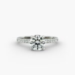 The Petite Pavé Crown hidden halo engagement ring in platinum with a round diamond.