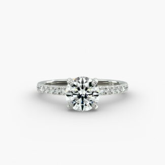 The Petite Pavé Crown hidden halo engagement ring in platinum with a round diamond.