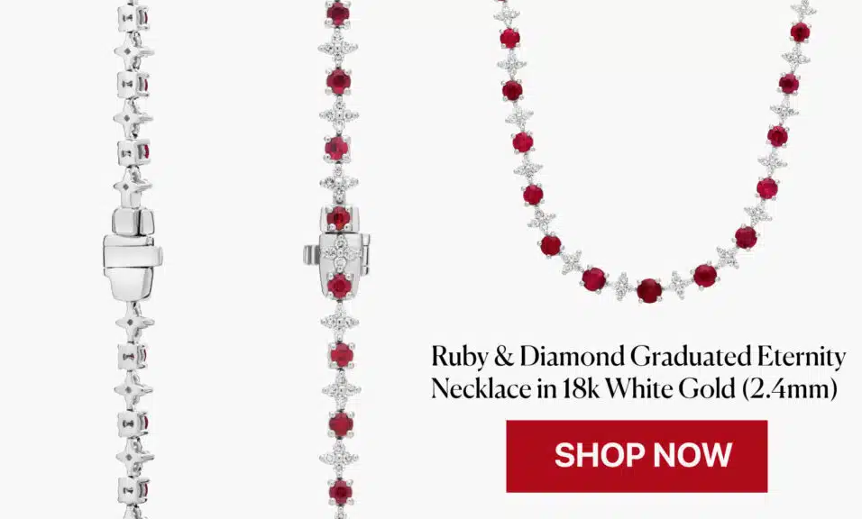 An extraordinary, heirloom-quality graduated eternity necklace from Blue Nile, featuring a flawless line of deep red rubies alternating with scintillating starburst diamond clusters in 18k white gold.
