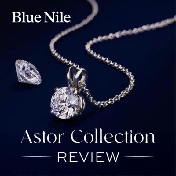 A Blue Nile diamond solitaire pendant from the Astor Collection, next to a loose round diamond. Text overlay reads "Astor Collection REVIEW".