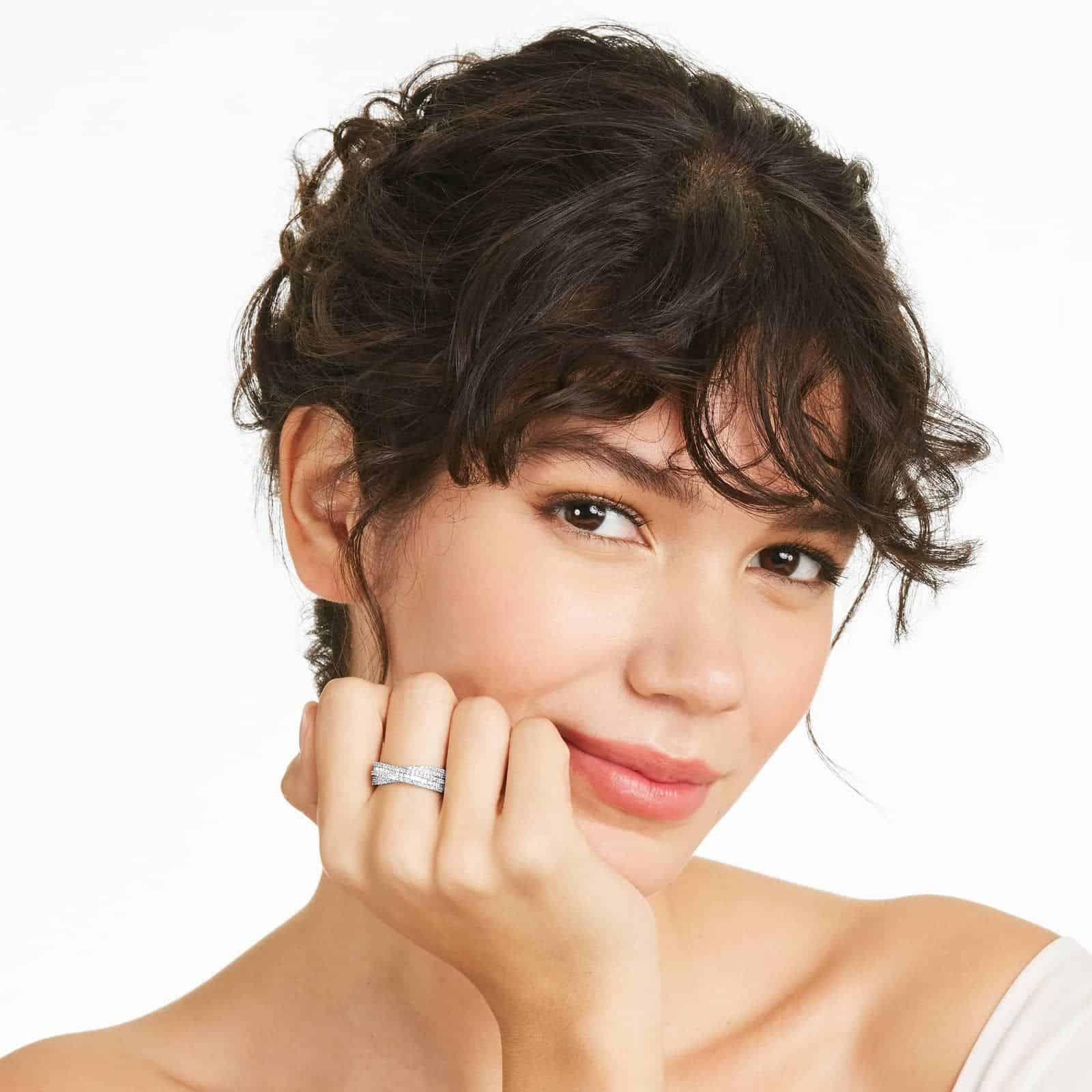 A model wearing the 0.80 ctw crossover diamond statement ring on her index finger, showing how its wide, multi-band design looks on the hand.