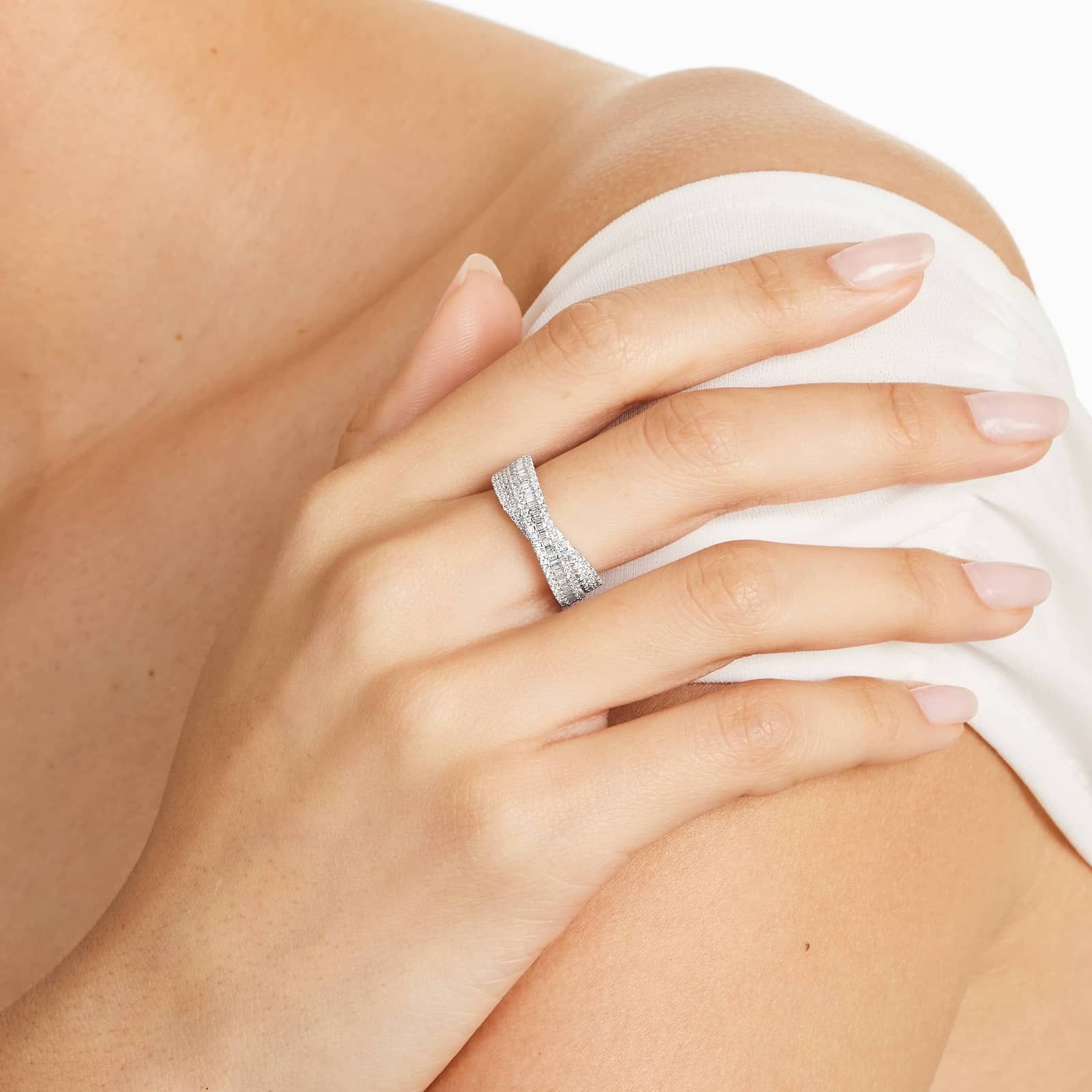 A model wearing the 0.80 ctw crossover diamond statement ring on her index finger, showing how its wide, multi-band design looks on the hand.