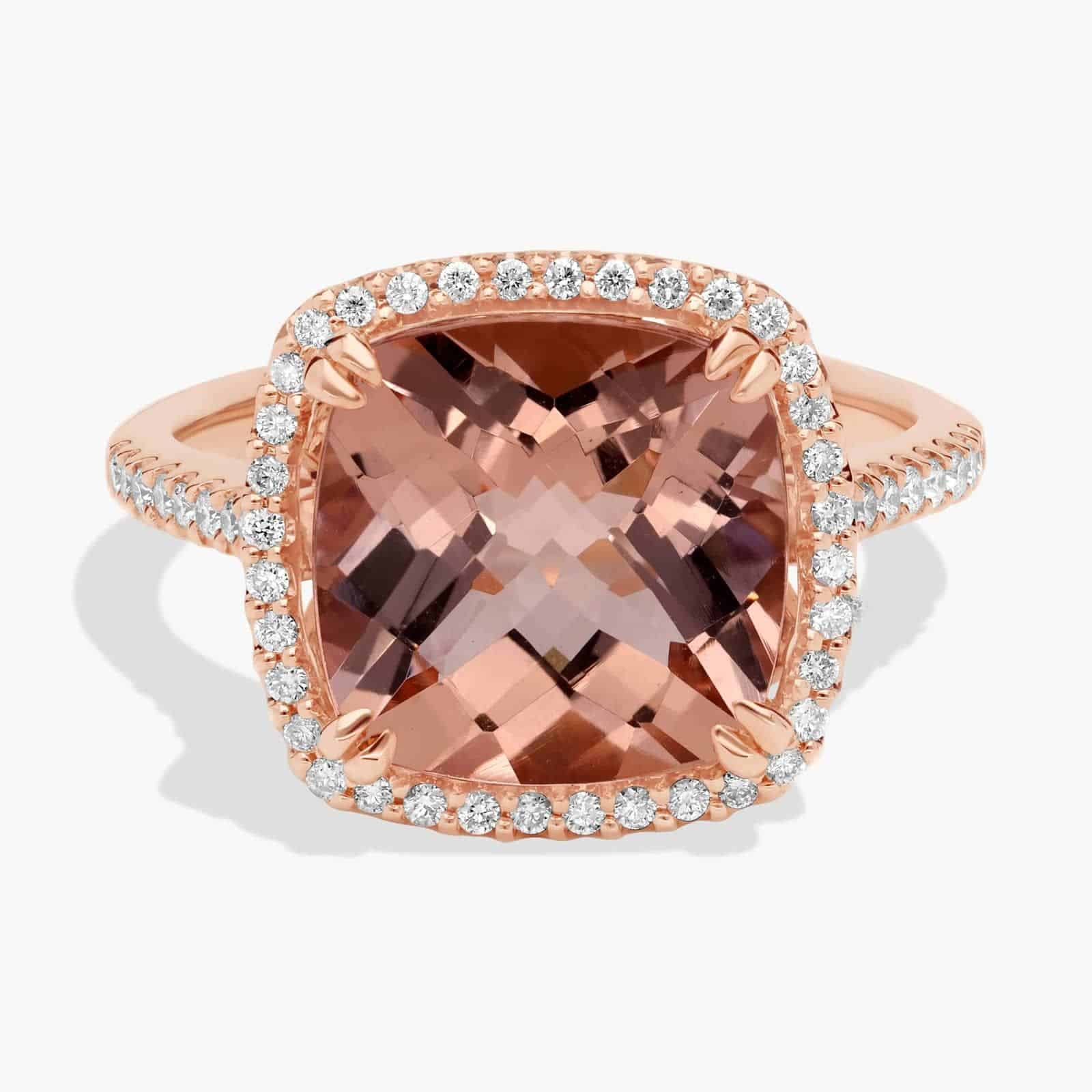 A close-up studio shot of a **cushion-cut morganite diamond halo ring** on a white background, showcasing the brilliant center stone and the sparkling pavé-set diamonds.