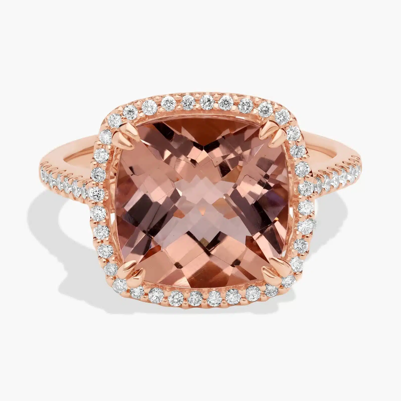 A close-up studio shot of a **cushion-cut morganite diamond halo ring** on a white background, showcasing the brilliant center stone and the sparkling pavé-set diamonds.