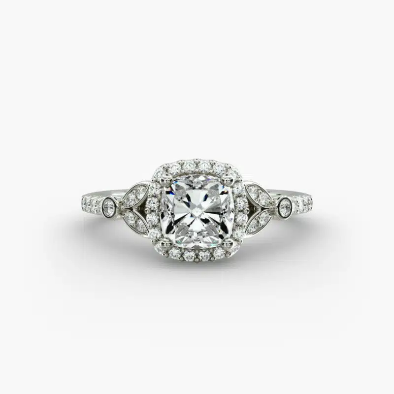 A high-resolution studio image of a GIA 1.50 carat cushion modified diamond engagement ring on a white background, highlighting the Ideal Cut and the intricate details of the halo and pavé setting.