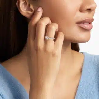 GIA 5.00 carat cushion diamond engagement ring on a woman's hand, highlighting the French pavé platinum band and the magnificent center stone.