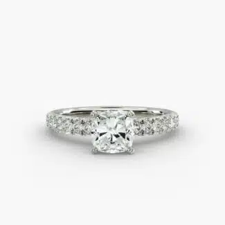Close-up of a GIA 5.00 carat cushion modified diamond engagement ring on a white background, showcasing the intricate French pavé setting and the brilliant platinum craftsmanship.