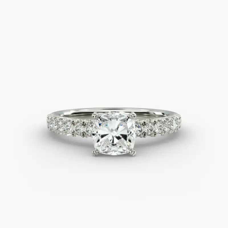Close-up of a GIA 5.00 carat cushion modified diamond engagement ring on a white background, showcasing the intricate French pavé setting and the brilliant platinum craftsmanship.