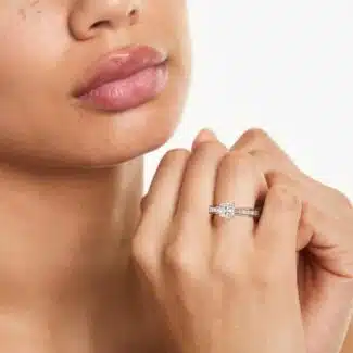 A GIA 5.02 carat flawless cushion-cut diamond engagement ring on a hand, highlighting the brilliant center stone and the sparkling pavé 14K white gold band.