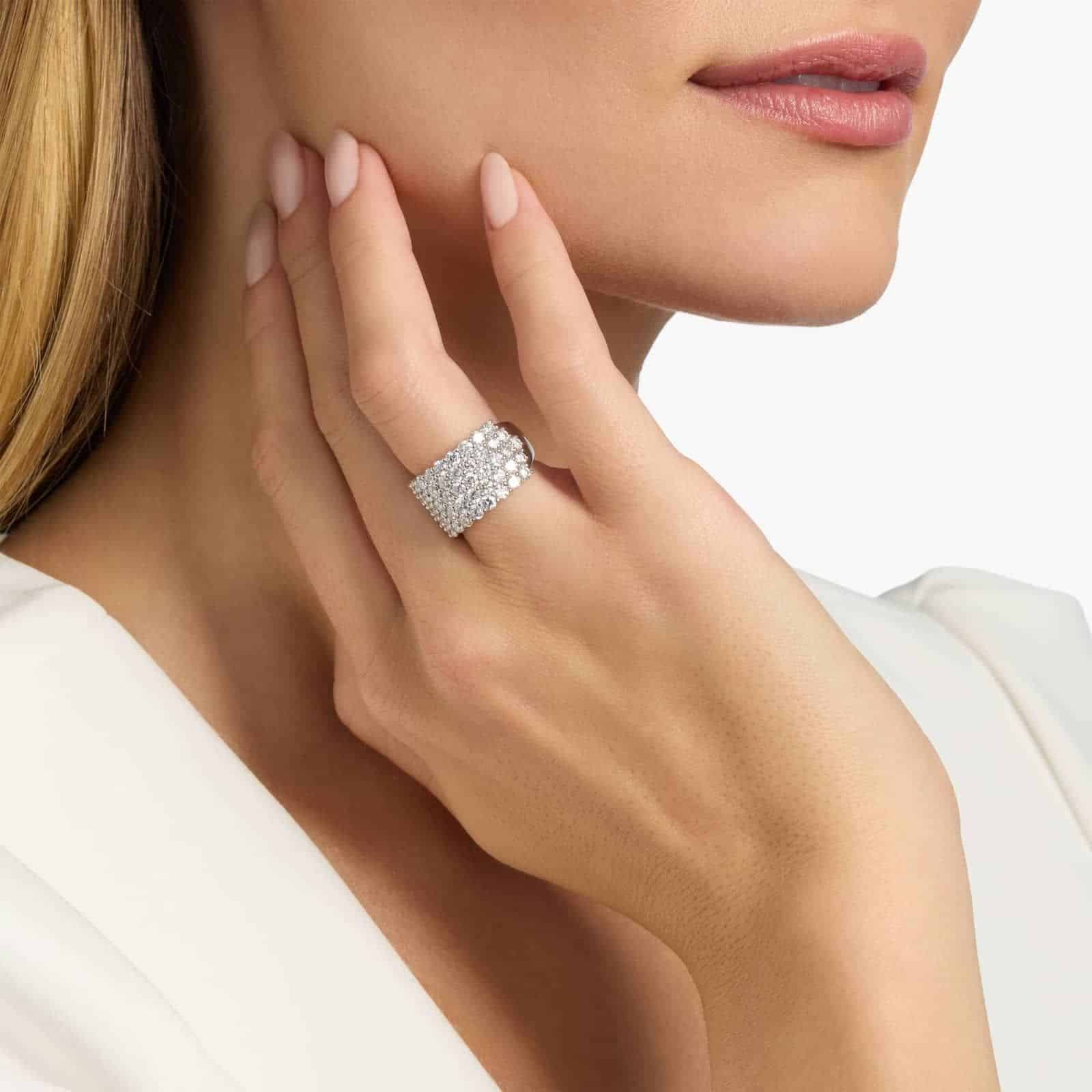 A model's hand wearing the massive 3.50 ctw five-row pavé diamond ring, showcasing its substantial scale and incredible sparkle as a bold, luxurious statement piece.
