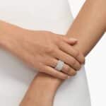 A model's hand wearing the massive 3.50 ctw five-row pavé diamond ring, showcasing its substantial scale and incredible sparkle as a bold, luxurious statement piece.