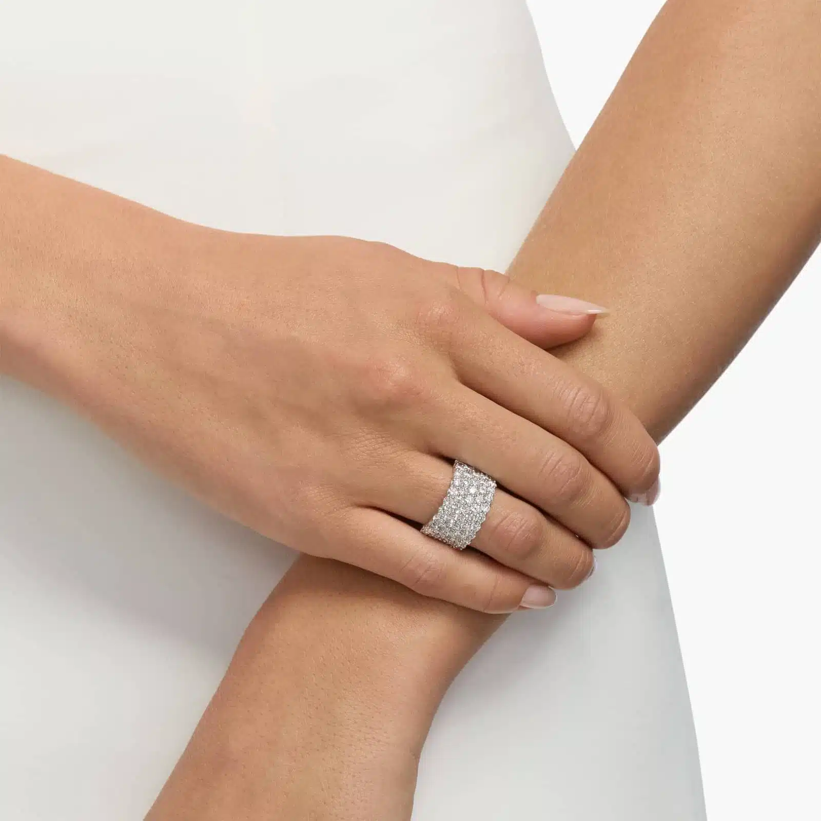 A model's hand wearing the massive 3.50 ctw five-row pavé diamond ring, showcasing its substantial scale and incredible sparkle as a bold, luxurious statement piece.