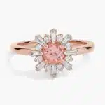 A close-up studio shot of a **morganite and baguette diamond halo ring** on a white background, highlighting the contrast between the round center stone and the linear baguette-cut diamonds.