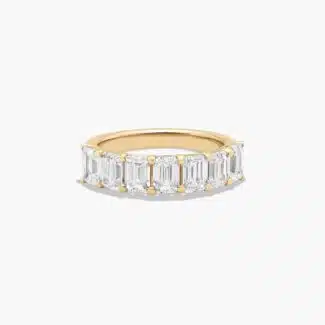 A seven stone emerald cut lab diamond anniversary ring with 2 ctw of stones set in a 14k yellow gold shared prong band, shown on a white background.