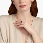 A woman's hand wearing a large **Square Fire Morganite Engagement Ring**, showcasing the impressive 14x14mm cushion-cut morganite and the sparkling pavé diamond band in 18K white gold.