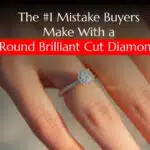 A close-up of a woman's hand wearing a Round Brilliant Cut Diamond engagement ring with a pave setting. The hand is softly lit, and the background is a blurred, sandy color.