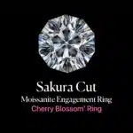 Feature image for a guide to the Sakura Cut moissanite engagement ring, also known as the 'Cherry Blossom' Ring. The image shows a detailed, top-down view of a Sakura Cut gemstone against a solid black background. The intricate, 8-petal floral facet pattern is clearly visible, showcasing the unique artistry of the cut. The text below reads "Sakura Cut Moissanite Engagement Ring" and, in pink, "'Cherry Blossom' Ring".