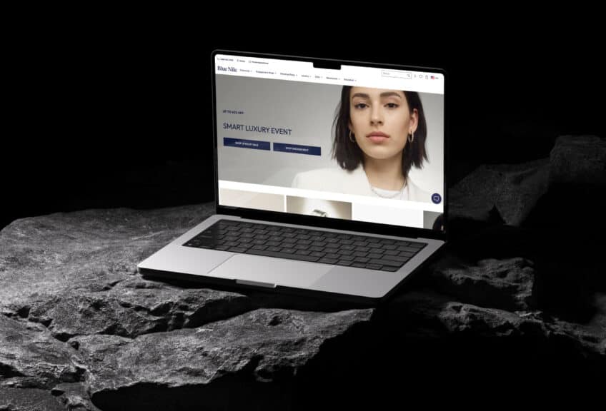 A laptop displaying the Blue Nile homepage, one of the best places to buy engagement rings due to its trusted brand name and huge inventory of classic and designer styles.