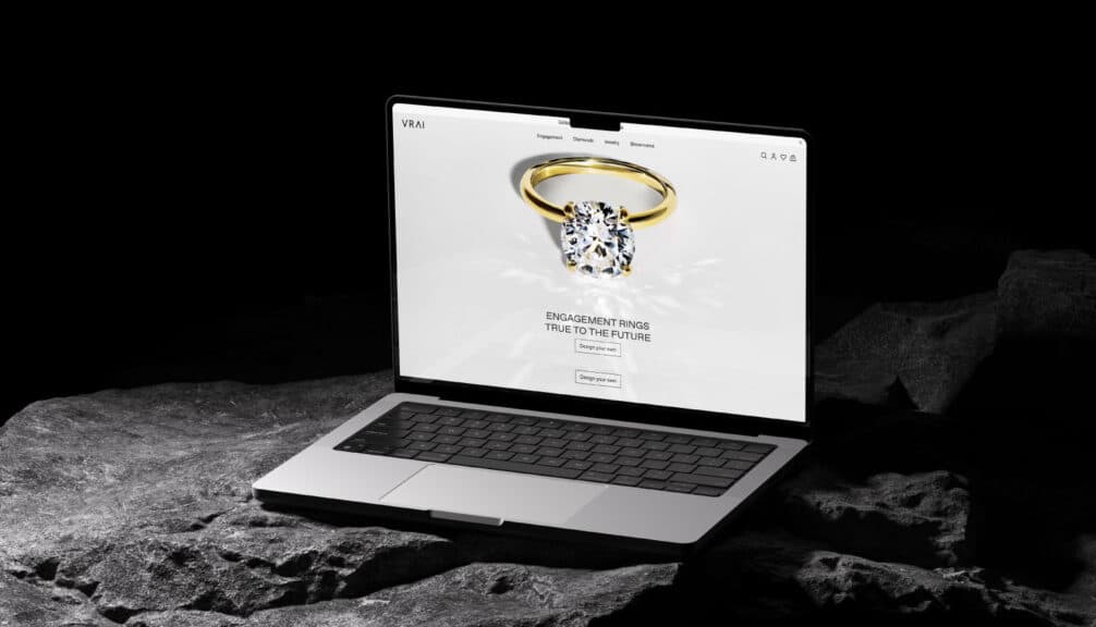 A laptop displaying the VRAI homepage, showcasing their high-design aesthetic and focus on sustainable lab-grown diamonds, making them one of the best places to buy engagement rings for the eco-conscious consumer.