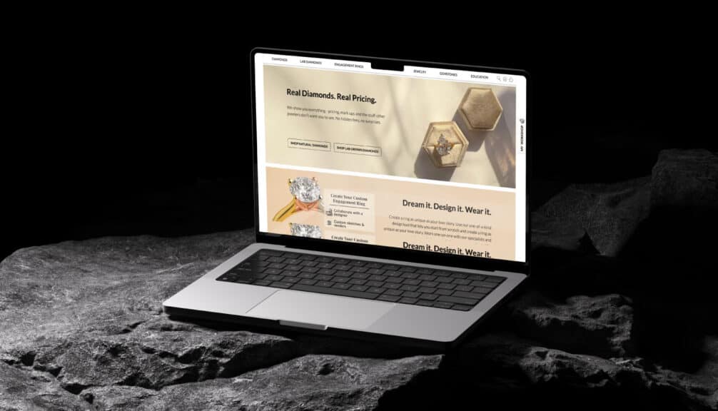 A laptop displaying the Ritani homepage and its slogan "Real Diamonds. Real Pricing," highlighting their transparent approach, a key reason they are one of the best places to buy engagement rings for value-conscious shoppers.