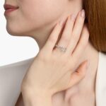 A woman's hand wearing a luxurious 3 carat radiant cut diamond ring with a French Pavé band in platinum.