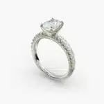 A close-up studio shot of a 3ct radiant cut diamond ring, highlighting the G-VVS2 clarity of the center stone and the intricate pavé setting.