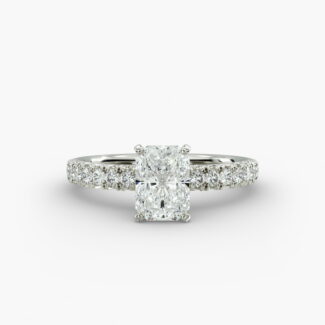 A close-up studio shot of a 3ct radiant cut diamond ring, highlighting the G-VVS2 clarity of the center stone and the intricate pavé setting.