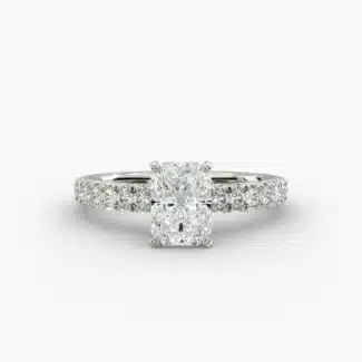 A close-up studio shot of a 3ct radiant cut diamond ring, highlighting the G-VVS2 clarity of the center stone and the intricate pavé setting.