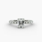 A close-up studio shot of a **7 carat diamond ring**, highlighting the stunning clarity of the emerald cut diamond and the delicate detail of the French pavé side stones.