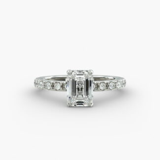 A close-up studio shot of a **7 carat diamond ring**, highlighting the stunning clarity of the emerald cut diamond and the delicate detail of the French pavé side stones.