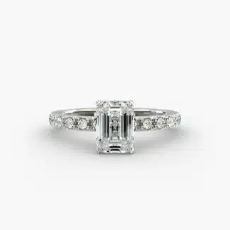 A close-up studio shot of a **7 carat diamond ring**, highlighting the stunning clarity of the emerald cut diamond and the delicate detail of the French pavé side stones.