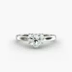 A close-up studio shot of a **7 carat diamond ring**, highlighting the stunning D-VS2 heart diamond and the elegant tapered cathedral setting in platinum.