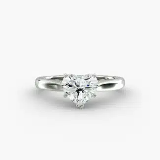 A close-up studio shot of a **7 carat diamond ring**, highlighting the stunning D-VS2 heart diamond and the elegant tapered cathedral setting in platinum.