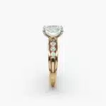 A close-up side view of a 2.5 carat radiant cut diamond ring in 14k yellow gold, highlighting the channel-set diamonds.
